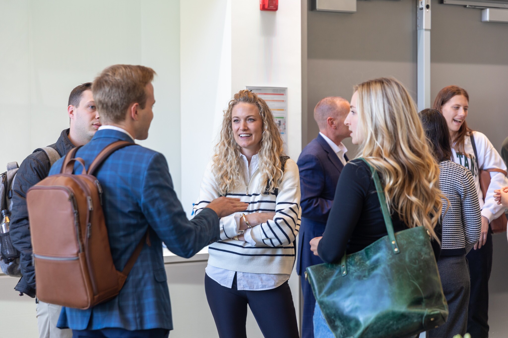 Four students engaging in conversation standing in a circle.