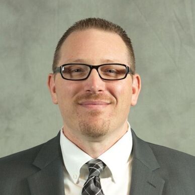 A professional headshot of Zachariah Rutledge, PhD