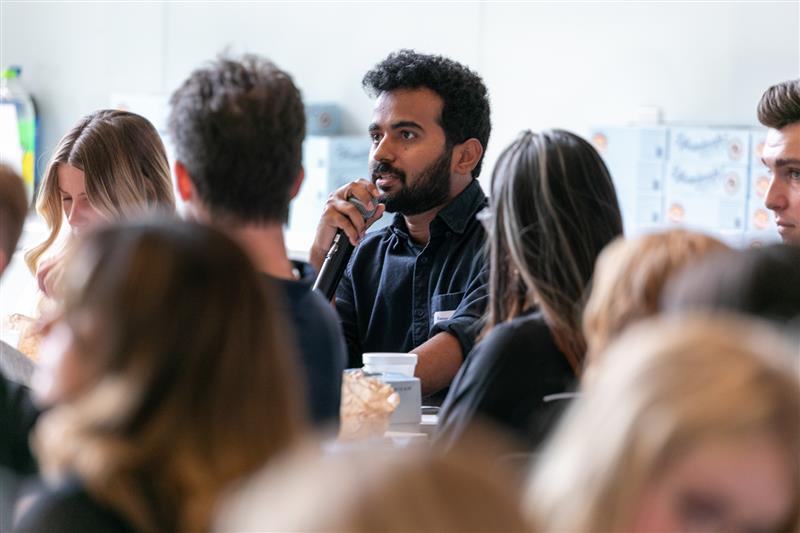 Event attendee speaking into microphone
