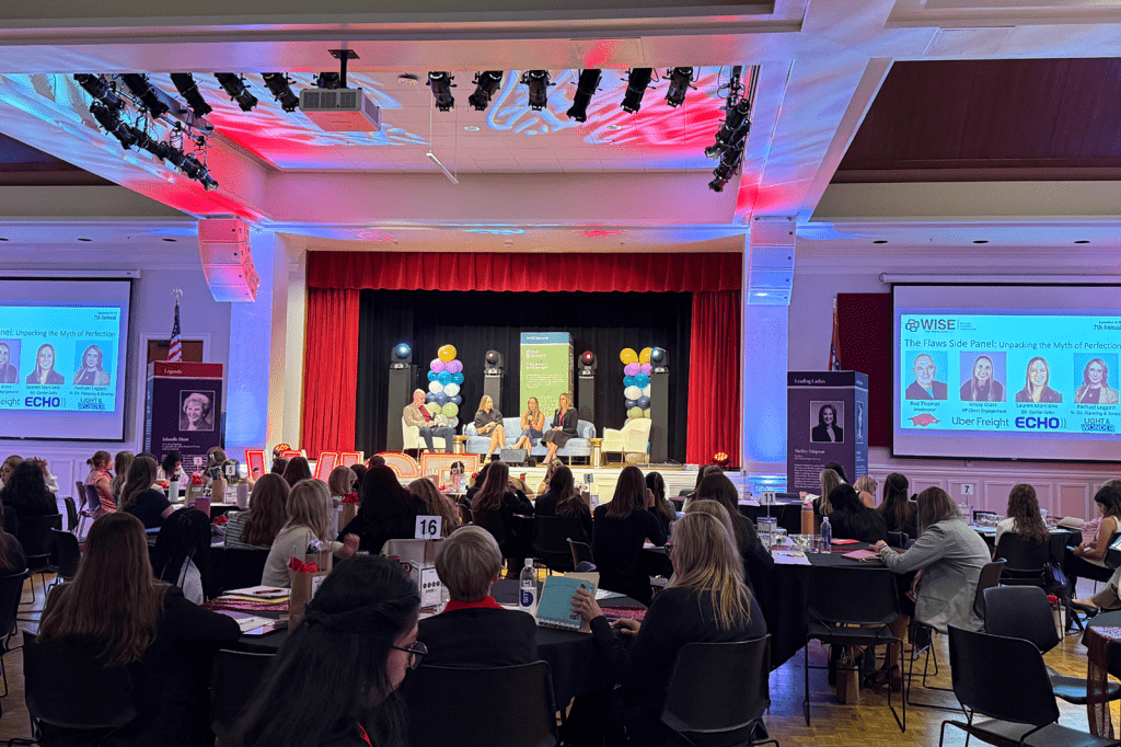 Attendees listening to conference presentation