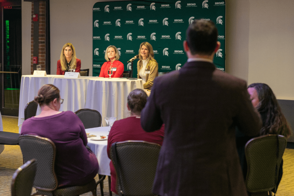 Panelists listening to standing participant