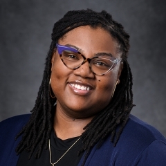 Headshot of Jessica Gray, a black woman smiling and wearing glasses