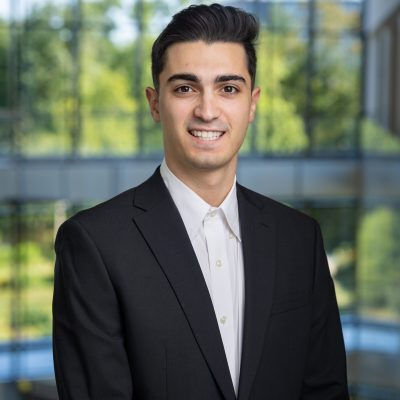 A professional headshot of Than Karapatsakis