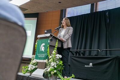 A student scholarship recipient giving a speech at the podium.