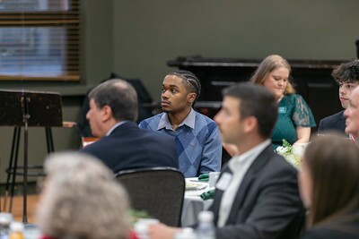 Students sitting at a table during the awards reception.