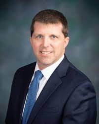 A professional headshot of Tim Boring