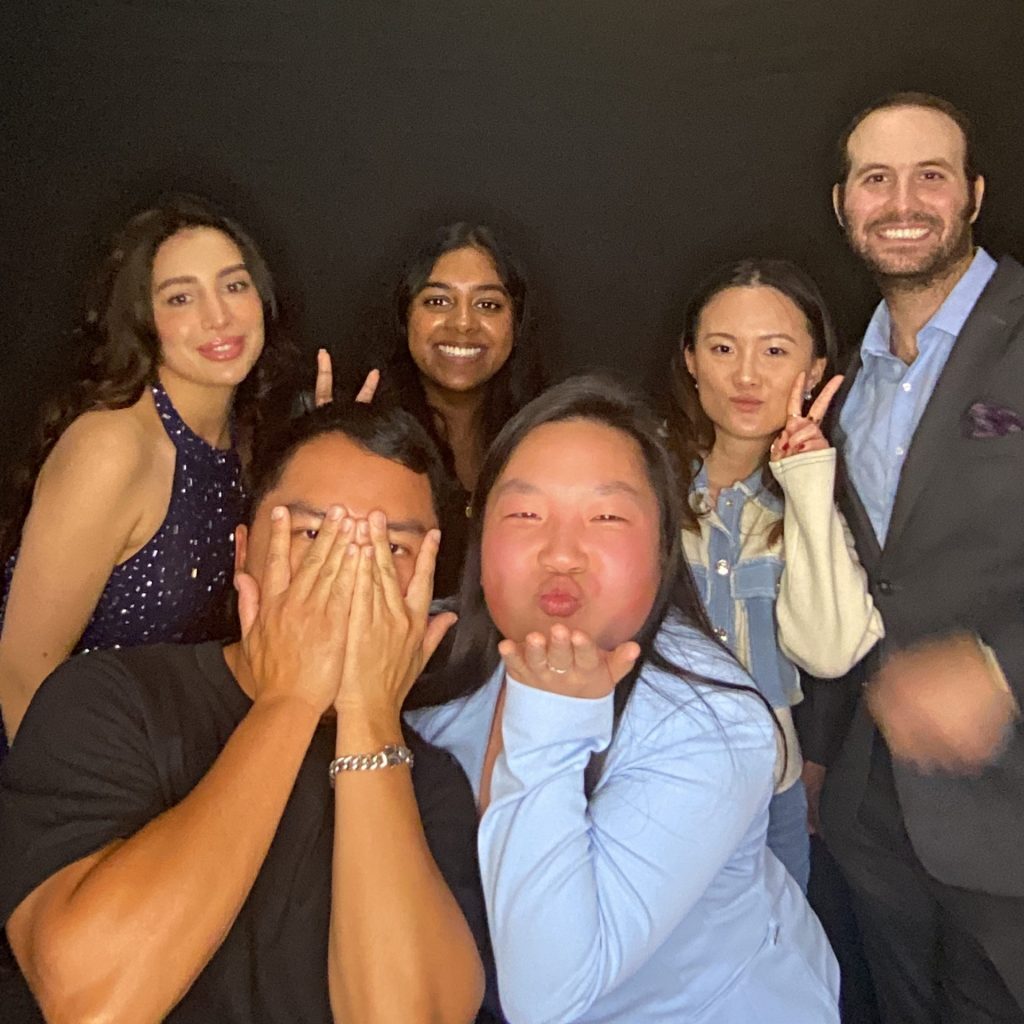 photo booth photo of several young adults smiling and making silly faces