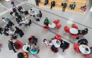 Overhead shot of students sitting at tables in Minskoff Pavilion 