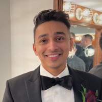 a young man in a bowtie smiles