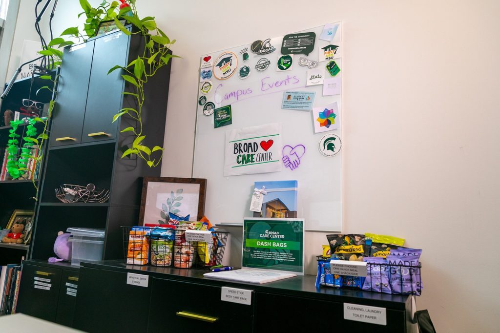 File cabinets with pantry items stacked on top and posters hanging on walls