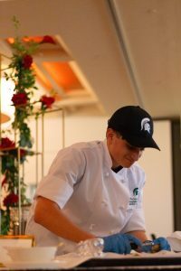 Student chef working at Les Gourmets 