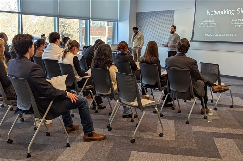 Seated event participants listening to speaker