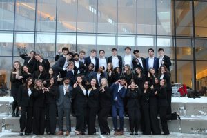 Group photo of students in business attire making funny faces