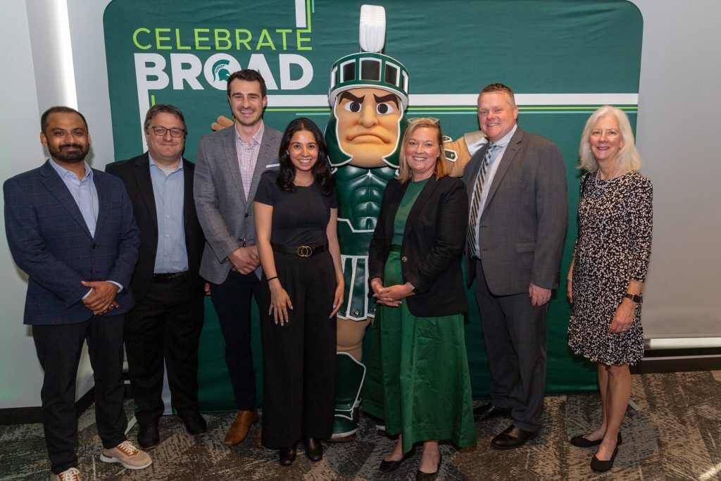 Faculty, staff and students pose for a group photo with the Michigan State Spartan mascot at the Celebrate Broad event.