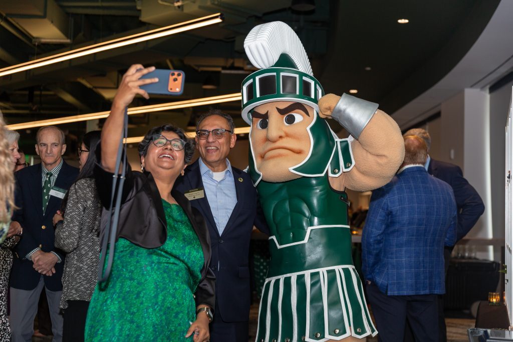 An attendee takes a selfie with Sparty and another guest during the Celebrate Broad celebration.