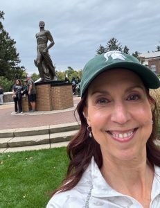 Woman in a selfie with the sparty statue 
