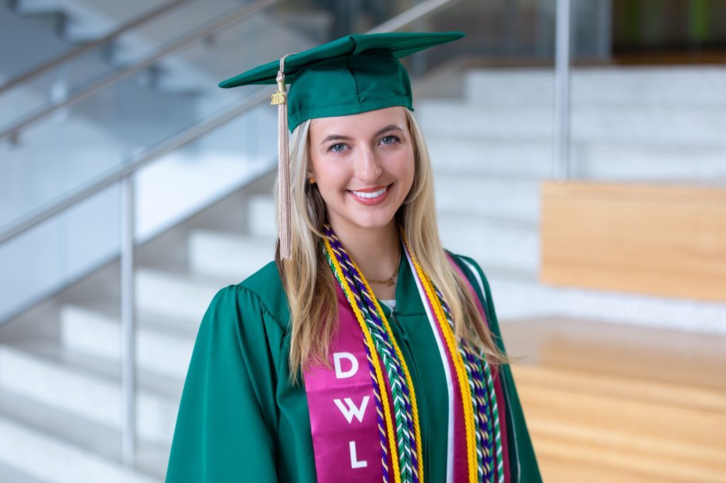 Headshot of Ennalyse Fretz in green graduation cap and gown