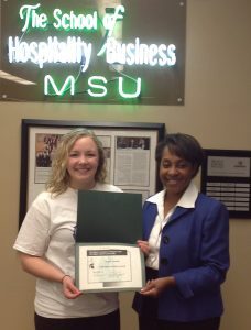 Photo of Angela Minielly receiving award from Authella Collins Hawks.