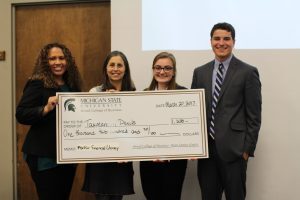 Winners of the MSUFCU Financial Literacy Competition and Kathy Petroni pose for a photo with a prize check