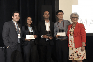 Anita Pansari accepts her award onstage