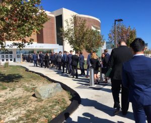 Students stand in a long line waiting to get into the event.