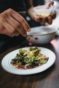 A salad is being made.