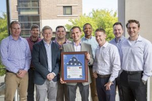 Veteran MBA students pose with the Afghanistan flag dedicated to the Broad College by Martin Barnes, who graduated in 2005.