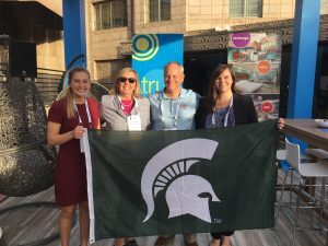 Kirby Homer and Lauren Trumbull are pictured with two Hospitality Business alumni