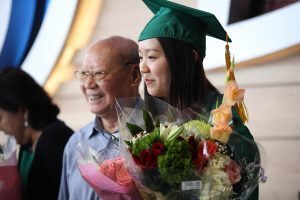 A Broad College of Business graduate poses for photos before commencement exercises on Saturday, May 5 at the Breslin Center. Photo by Matt Mitchell