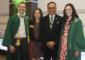 Eli Broad College of Business Associate Dean of Undergraduate Programs Kathy Petroni and Dean Sanjay Gupta, center, pose with a pair of graduates-to-be prior to commencement Saturday, May 5. Photo by Matthew Dae Smith