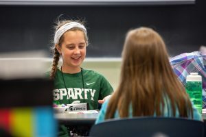 The granddaughter of a Spartan alum works on a project during the EmpowHER mini-retreat at the Grandparents University event. Photo by Jeff Seguin