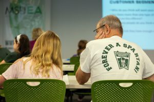 A Spartan alum and his granddaughter work on entrepreneurship during the Broad College Business Model Canvas session at Grandparents University. Photo by Jeff Seguin