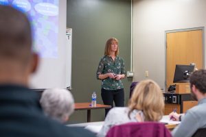 Becky Smith stands at the front of a classroom