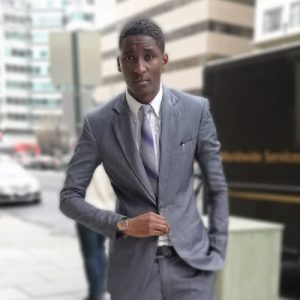 Pius Mithika in a suit and tie