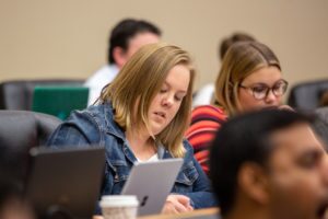 Broad MBA female student taking notes