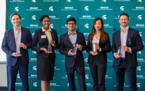 The Broad vs. Broad winning team, dressed professionally holding their awards.
