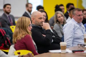 Executives from Meijer seated at a table, serve as a judges panel for the MBA students at this year's Extreme Green event.