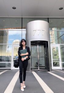 M.S. in Accounting student Daisy Wu pictured in professional clothing outside of an office building.