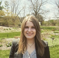 Professional image of Anne Swartz (B.A. Hospitality Business '20) outside on MSU's campus.
