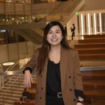 Professional image of Jennifer Yoo (B.A. Supply Chain Management '21) inside the Minskoff Pavilion on MSU's campus