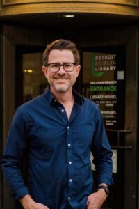 Image of John Stoll outside in front of the Detroit Public Library