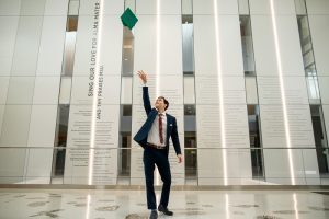 Brendan Connolly tossing his commencement cap inside the Minskoff Pavilion.