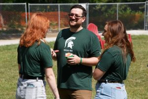 MBA students talk and eat ice cream outside the Minskoff Pavilion for Fall Welcome events
