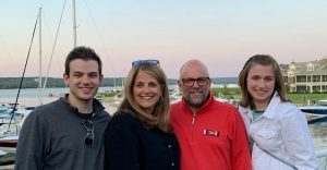 The Sitek family pose in front of a harbor.