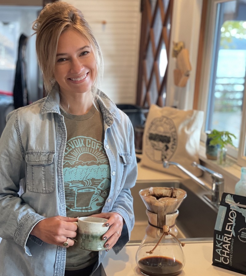 Lake Charlevoix Coffee Company founder Brittany (Brubaker) McNeil with a mug of coffee.